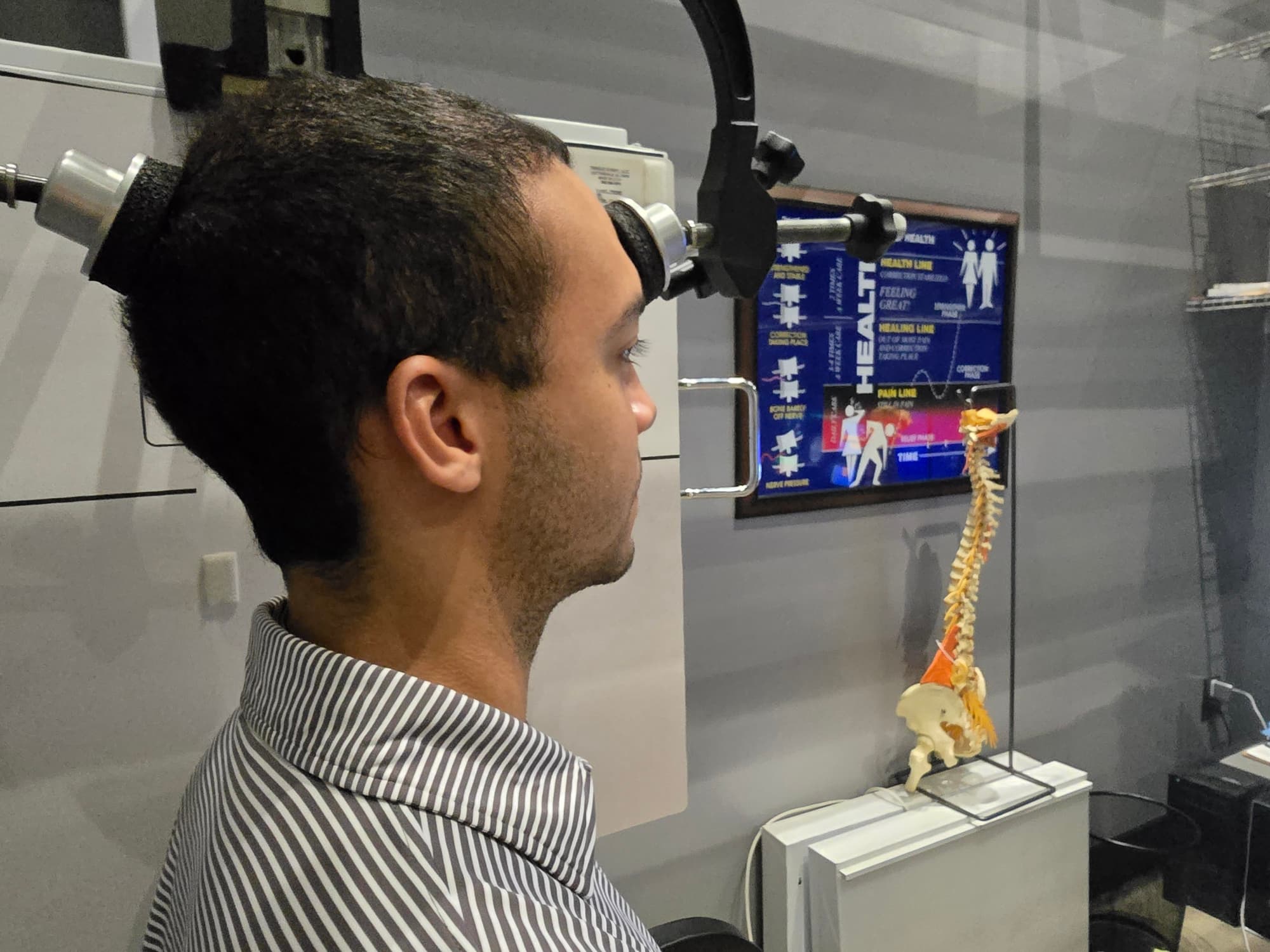 Dr. Porter providing gentle upper cervical chiropractic care to a smiling patient at Functional Chiropractic in Huntsville, AL
