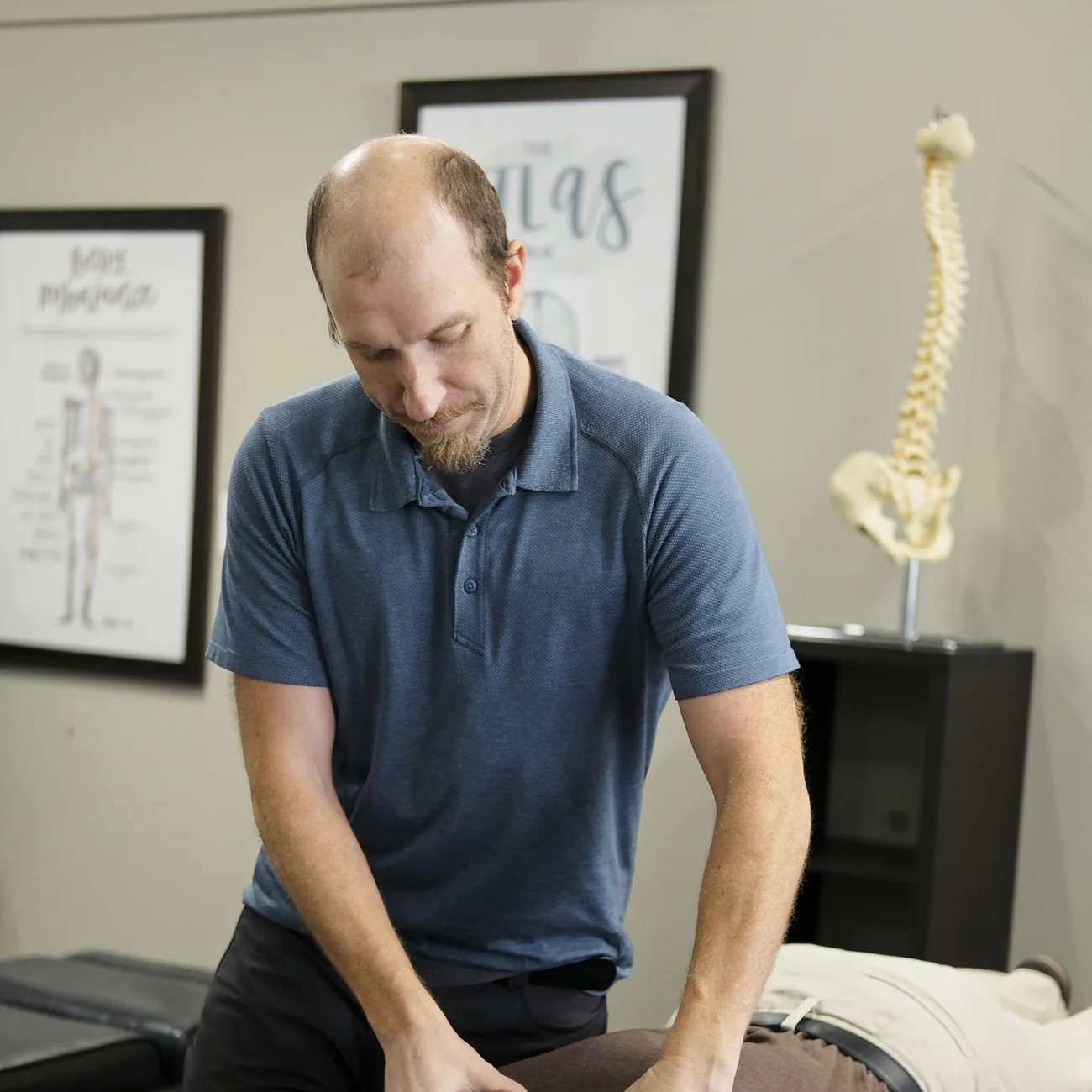 Dr. Porter providing gentle upper cervical chiropractic care to a smiling patient at Functional Chiropractic in Huntsville, AL